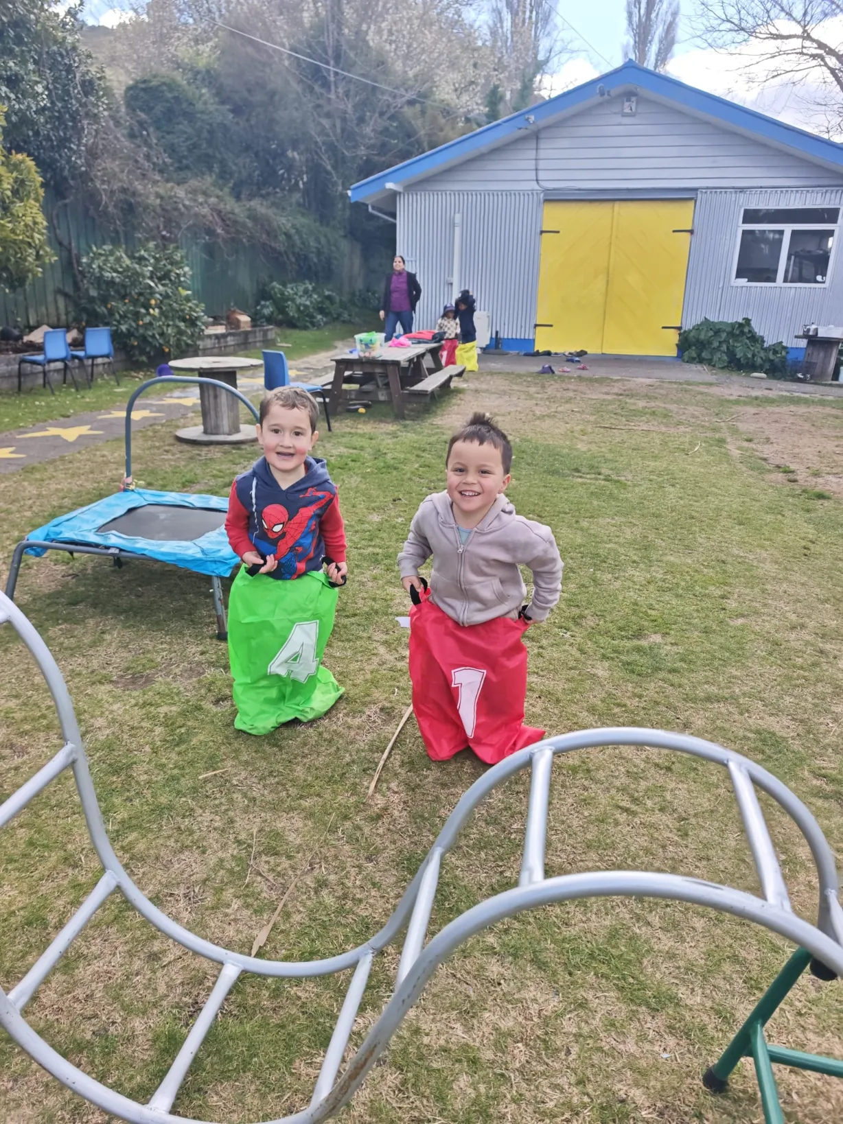 Tamariki racing in sacks across the grass