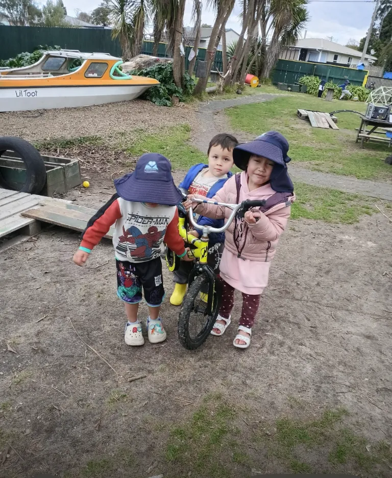 Tamariki riding bikes and scooters around the outdoor track